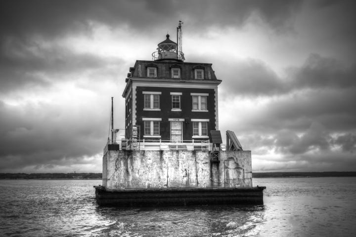 a large clock tower in the middle of a body of water